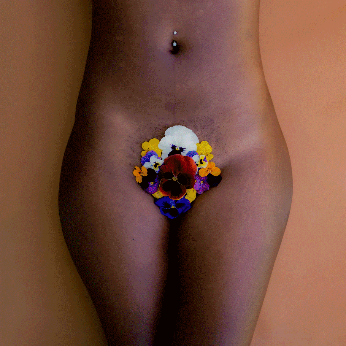 Women's lower bodies with flowers beautifully placed over their yonis